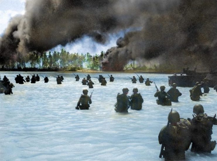 165th Infantry assault wave attacking Butaritari, Yellow Beach Two, find it slow going in the coral bottom waters. Japanese machine gun fire from the right flank makes it more difficult for them. Royston Leonard / mediadrumworld.com