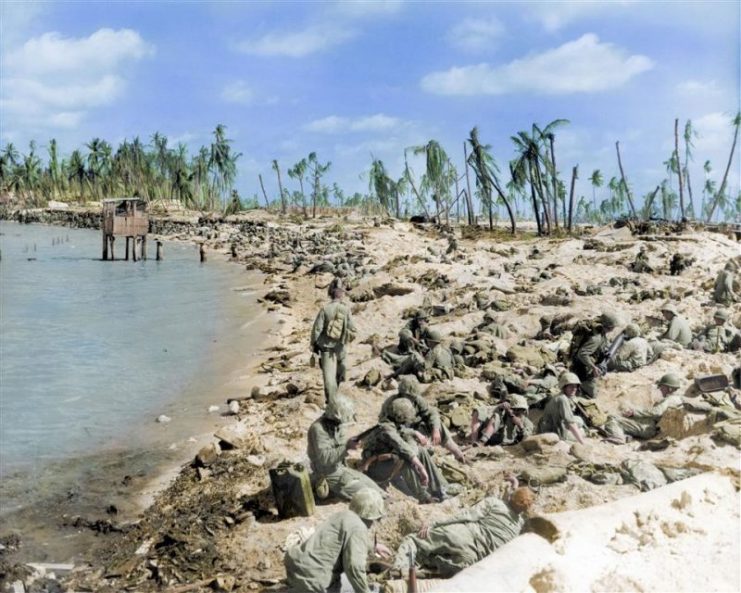 Cpl Robert E Voorhees standing while carrying supplies during the Battle of Tarawa at Red Beach, Bieto, Tarawa. Royston Leonard / mediadrumworld.com