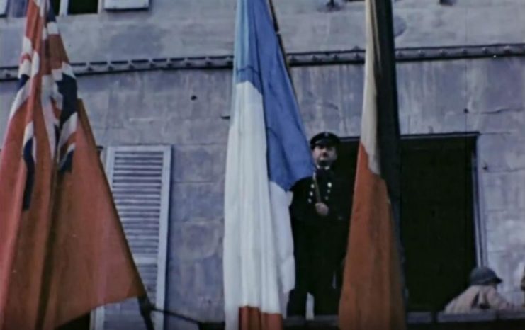 The French flag is raised high above the city once more following the eviction of the Nazis. Public Domain / mediadrumworld.com