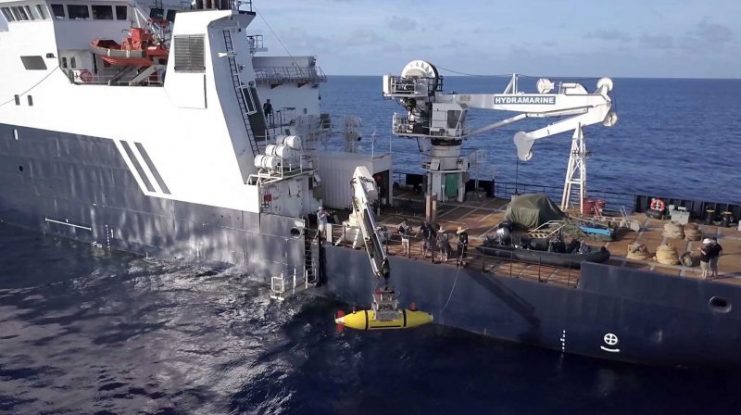 The AUV Hydroid Remus 6000 is deployed from the R/V Petrel. The autonomous underwater vehicle is capable of operations in up to 6,000 meters of water. Photo courtesy of Paul G. Allen