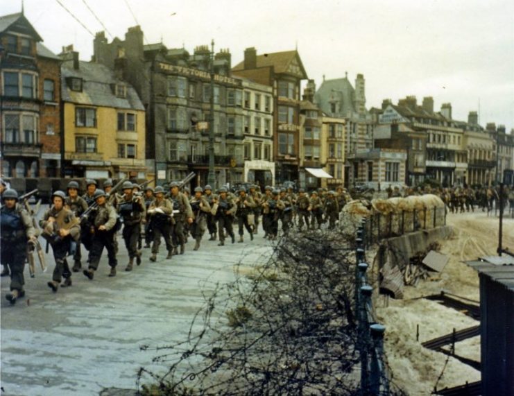 American troops marching through Weymouth on their way to the docks where they will be loaded into landing craft for the Normandy landings. June 1944.