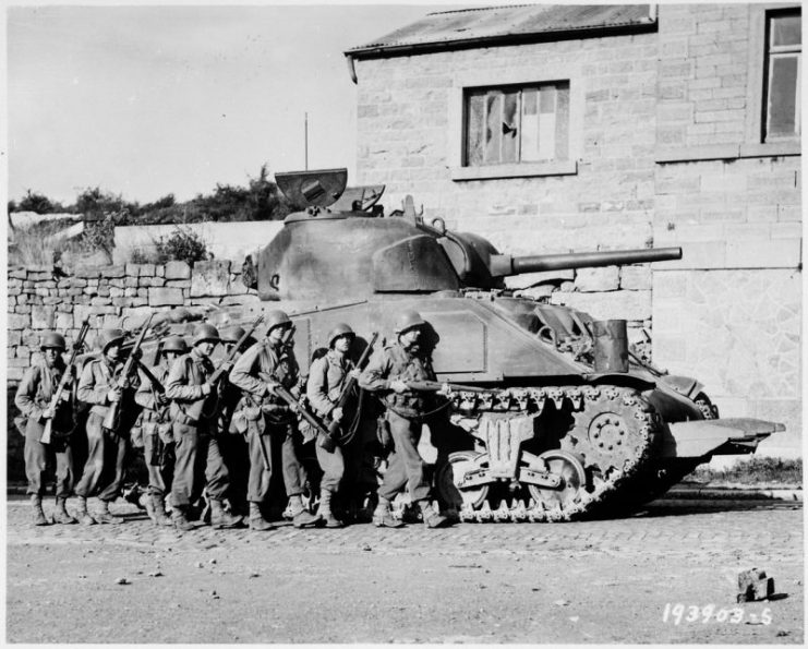60th Infantry soldiers alongside of a Sherman “Rhino” tank in Belgium