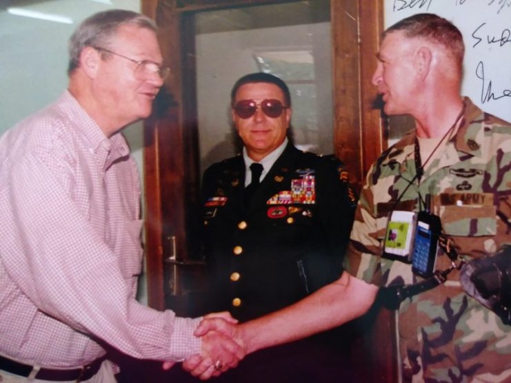 Suddarth, far right, is pictured shaking the hand of former U.S. Representative Ike Skelton while the Congressman was visiting Bosnia in 1999. Courtesy of Henry Suddarth