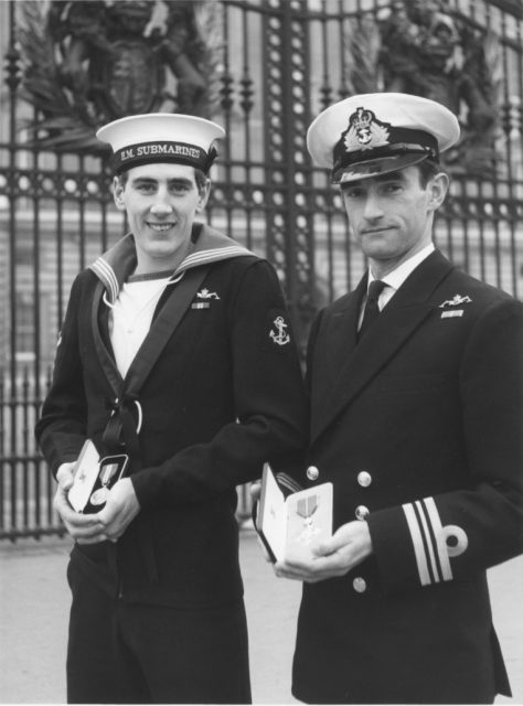 Eric Thompson (right) receives his MBE for actions taken during an emergency on a deterrent patrol.
