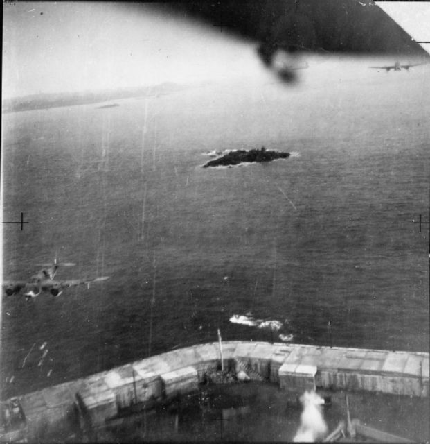 A low-level oblique photograph taken from one of 3 Bristol Beauforts of No. 86 Squadron RAF, attacking shipping in St Peter Port, Guernsey.