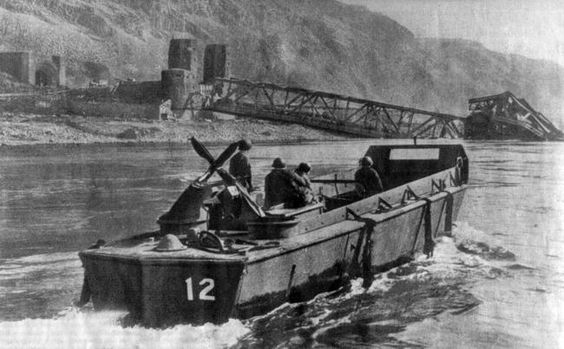 An American landing craft before the remains of the Ludendorff Bridge.