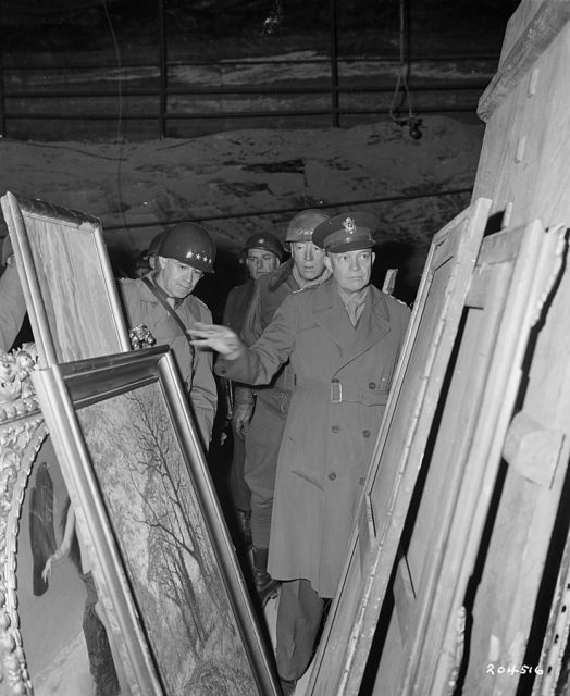 Gen. Dwight D. Eisenhower inspects stolen artwork in the Merkers salt mines. Behind Eisenhower are General Omar N. Bradley (left), CG of the 12th Army Group, and (right) LT Gen George S. Patton, Jr, CG, 3rd U.S. Army.