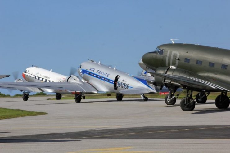 A pair of Douglas DC-3 and C-47 Dakota painted with invasion stripes.
