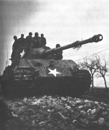 Captured German Tiger II (Königstiger) tank with temporary U.S. markings. Note 88-mm gun with muzzle brake.