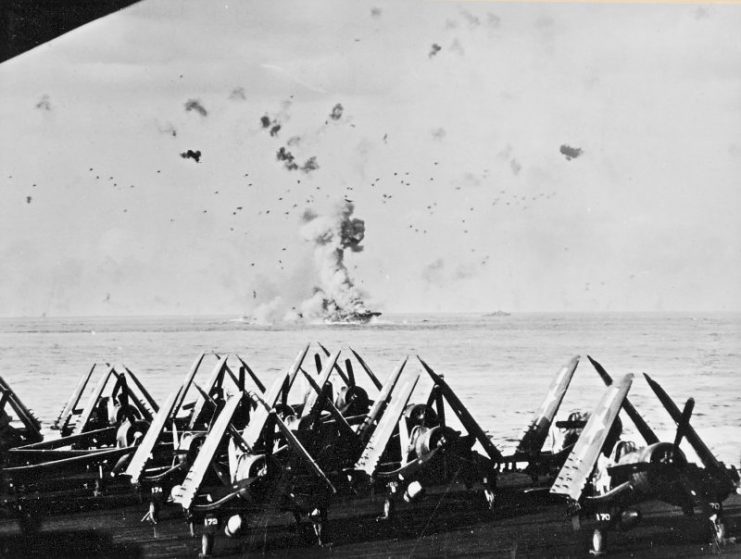 he U.S. Navy aircraft carrier USS Enterprise (CV-6) in flames after the ship was hit by a kamikaze off Kyushu. The forward elevator is blown up by the blast. The photo was taken from USS Essex (CV-9). Vought F4U-1 Corsairs of Fighting Boming Squadron 83 (VBF-83) are visible in the foreground.