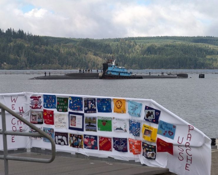 A colorful banner made by family members awaits the crew as the Sturgeon-class submarine USS Parche (SSN 683).