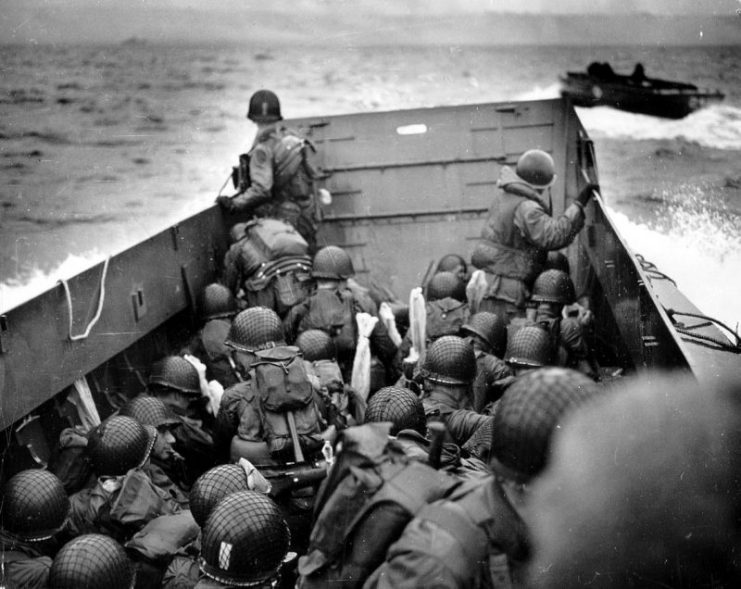 US troops crouch inside a LCVP landing craft, just before landing on “Omaha”