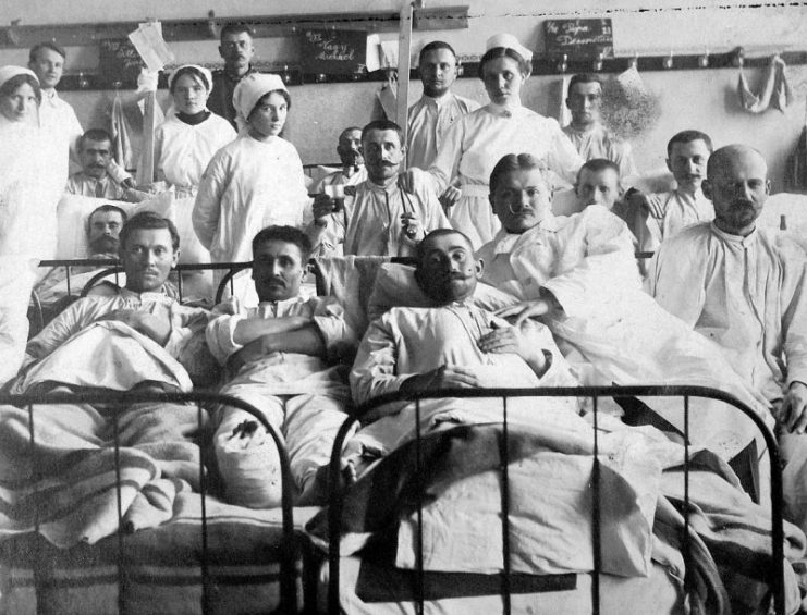 WWI nurses in a hospital with soldiers as patients.