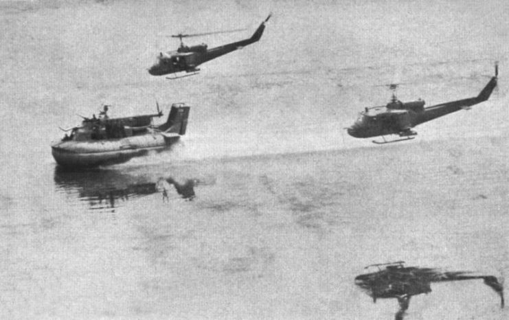 Two U.S. Navy Bell UH-1E Huey of Light Helicopter Attack Squadron 3 (HAL-3) accompany a Patrol Air Cushion Vehicle in the Plain of Reeds, Vietnam, circa 1966.