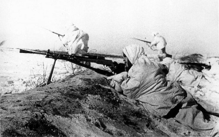 A Soviet machine gunner covers attacking infantry near Tula, in November 1941.