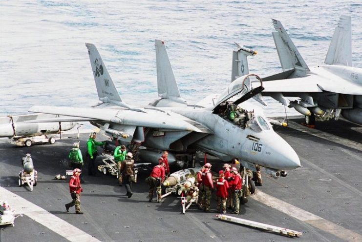 Sailors prepare an F-14 Tomcat for a flight.