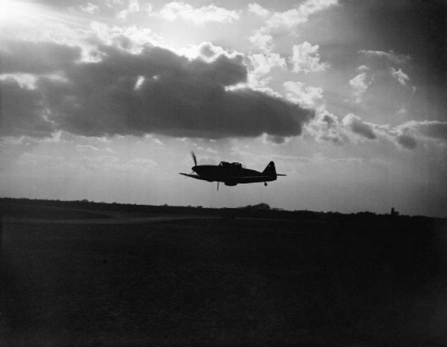 Boulton Paul Defiant Mark I night-fighter of No. 264 Squadron RAF, silhouetted against the clouds during a low-level pass over its base at Biggin Hill, Kent.