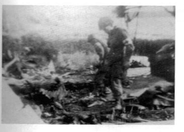This picture’s original caption identifies Major Daniel McIlvoy of the 82nd Airborne Division’s 505th Medical Detachment inspecting the wreckage of a C-47 in Normandy. Based upon the caption stating the Picauville location and that the aircraft had burned, it is most likely that this was Joe Sullivan’s aircraft.