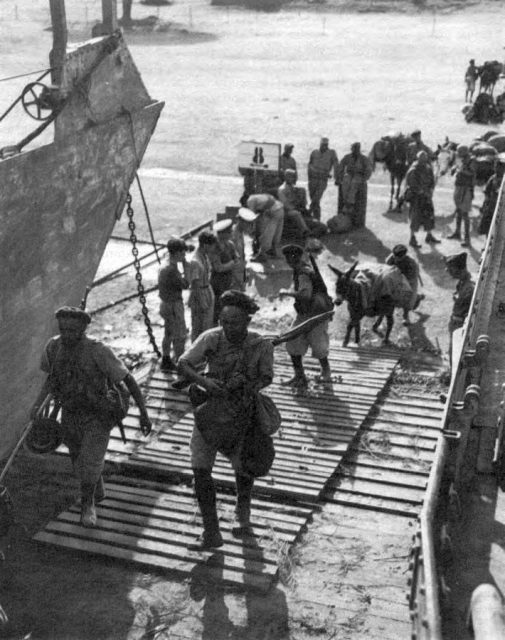 Goumiers of the 2nd group of Moroccan tabors (2d GTM) boarding landing craft at Corsica for the invasion of Elba. (2d GTM reinforced the 9th colonial infantry division for the Elba operation)