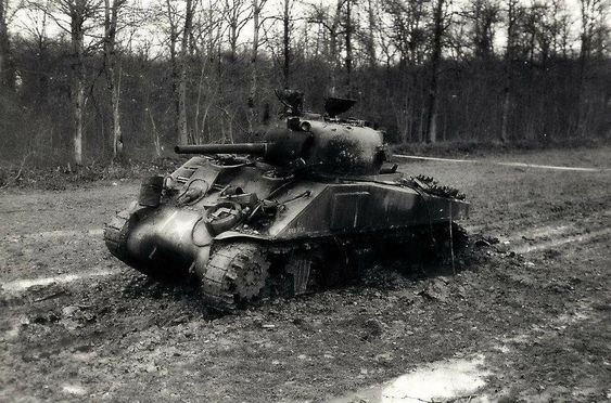 “Bar Fly” an M4 Sherman of the 6th Armored Division knocked out by a German land mine near Hellimer France, November 1944