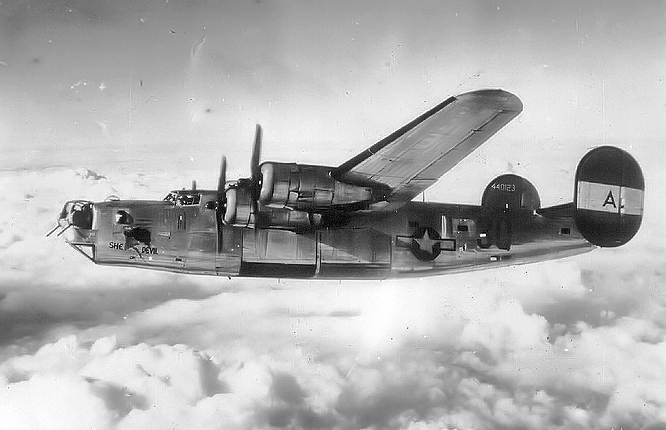 B-24 with nose art “She Devil” in flight, 1944.