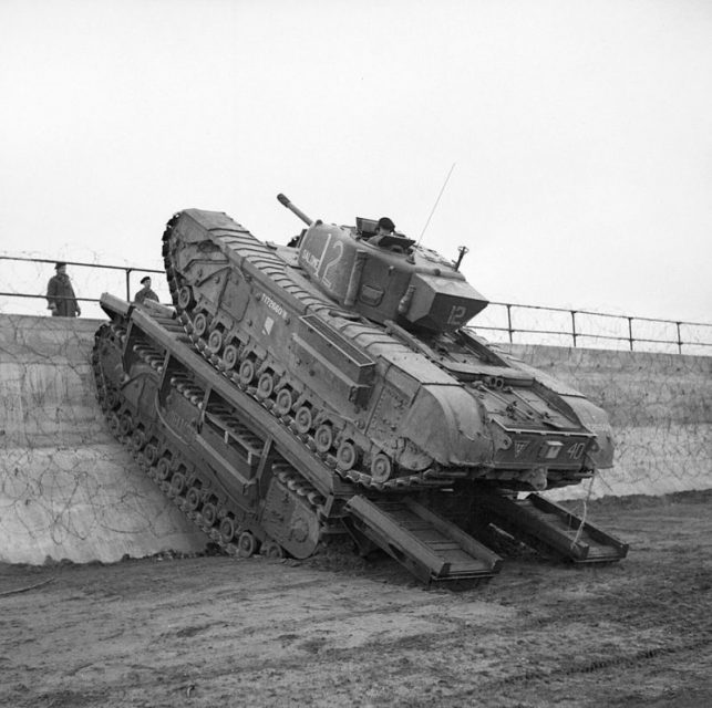 A Churchill tank uses a Churchill Ark to scale a sea wall, 79th Armoured Division, Saxmundham area, 11 March 1944.
