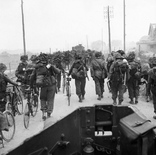 Troops from 3rd Division, some with bicycles, move inland from Sword Beach, 6 June 1944. Photograph taken from a Universal carrier.