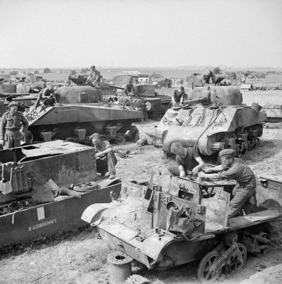 The remains of Sherman tanks and carriers waiting to be broken up at a vehicle dump in Normandy, 1 August 1944.