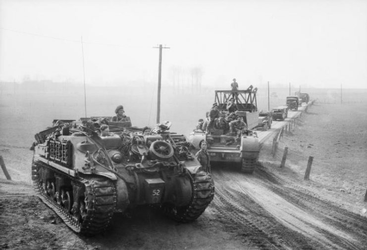 A Sherman ARV and other specialized armor moving up to cross the Rhine, 24 March 1945.
