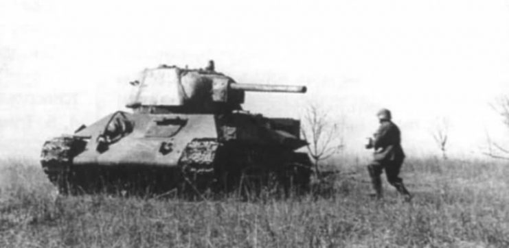 Abandoned T-34 with German soldier approaching.
