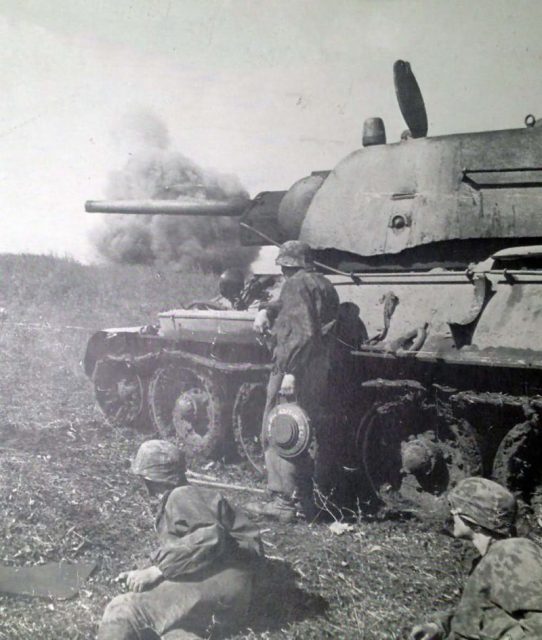 Abandoned T-34 with the Uralmash Turret. Panzer Grenadiers in foreground.