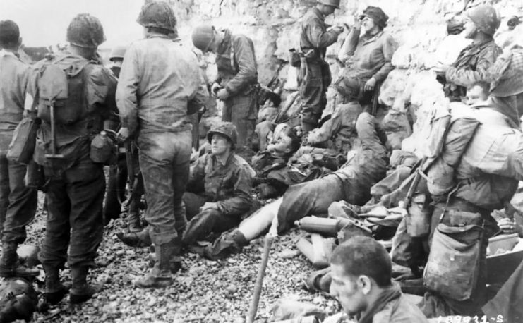 Assault troops of the 3rd Battalion, 16th RCT, from the first two waves, shelter under the chalk cliffs, which identify this as an area of Fox Red.