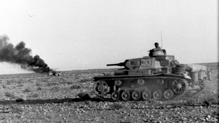 A Panzer III advances in the desert, April 1941. By Bundesarchiv – CC BY-SA 3.0 de