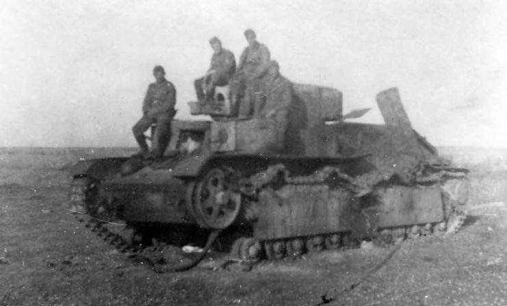 German Soldiers Pose Atop a Destroyed T-28 Tank.
