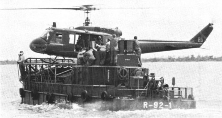 A U.S. Army Bell UH-1D/H Huey lands aboard an ATC(H) of River Assault Division 92, in 1967. The Armoured Troop Carriers were converted LCM-6 landing craft. RAD 92 was based on USS Whitfield County (LST-1169) in the Mekong Delta, Vietnam.