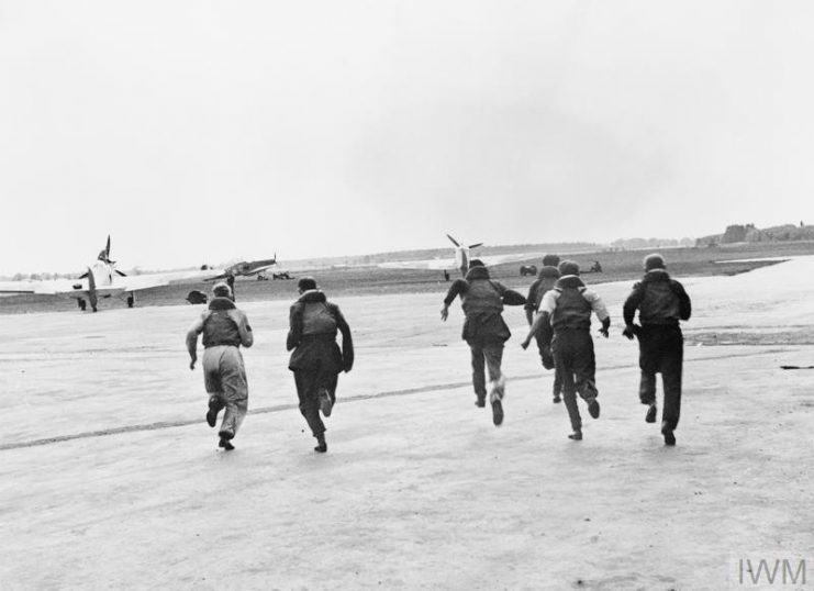 RAF pilots run to their aircraft. IWM