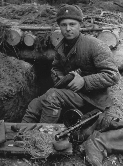 Soviet Soldier in a bunker with tools and sub-machine gun.