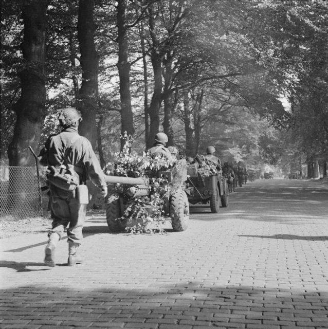 Men of the 2nd Battalion, South Staffordshire Regiment, of the 1st Airlanding Brigade, advance toward Arnhem, towing a 6-pounder anti-tank gun with them, 18 September.
