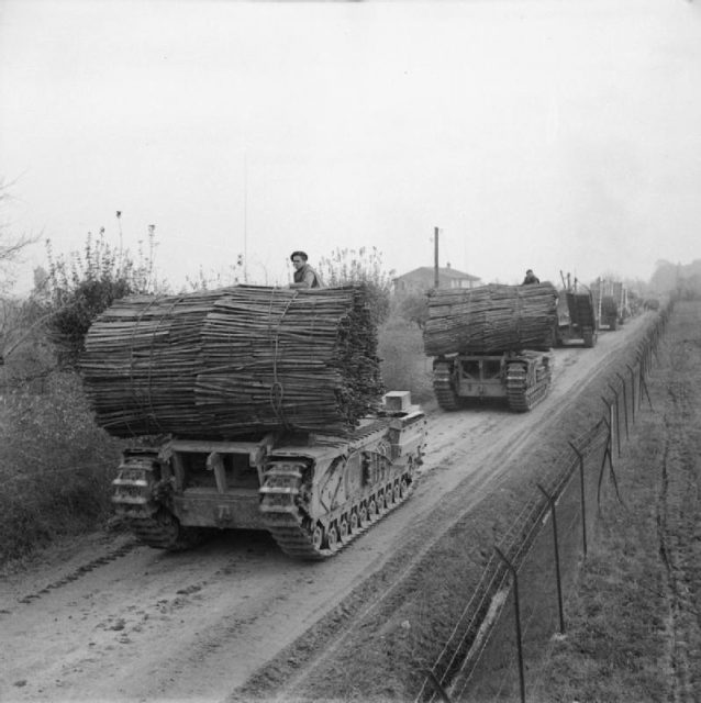 Churchill AVREs carrying fascines and Churchill ARKs passing through Forli, 9 November 1944.
