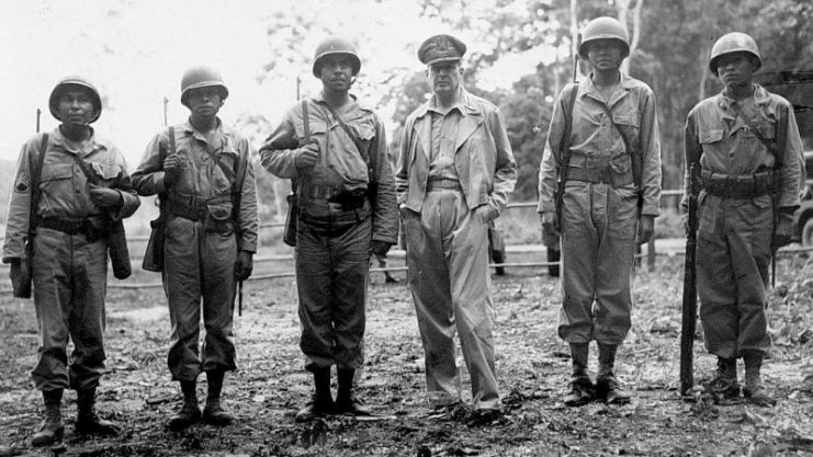 General Douglas MacArthur meeting five Native American troops serving in one unit, February 1944.