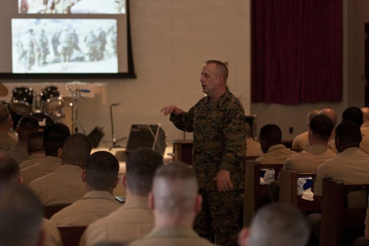 Sgt. Maj. Justin D. Lehew speaks with students and faculty participating in the Staff Non-Commissioned Officers Academy Feb. 6 at the West Chapel on Camp Hansen regarding his personal experiences in the Marine Corps and how those in attendance can expand their knowledge of history and tradition. Lehew earned the Navy Cross, the second highest award for combat valor after the Medal of Honor, for his actions March 23-24, 2003 during the Battle of An-Nasiriyah.
