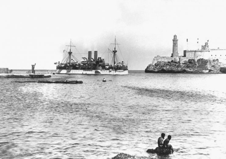 USS Maine entering Havana Harbor on 25 January 1898, where the ship would explode three weeks later. On the right is the old Morro Castle fortress.