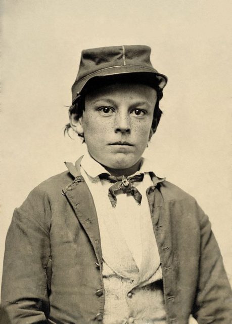 Photograph shows young soldier, possibly a drummer boy.
