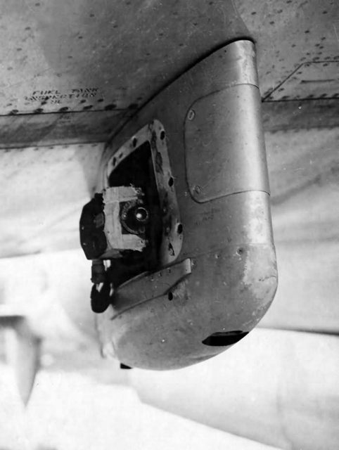 Aiming point camera on the bomb rack of P-38.