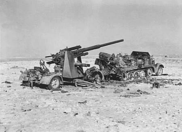 A burnt out German 88 mm FlaK 36 gun and its SdKfz 8 half track near El Alamein, Egypt.