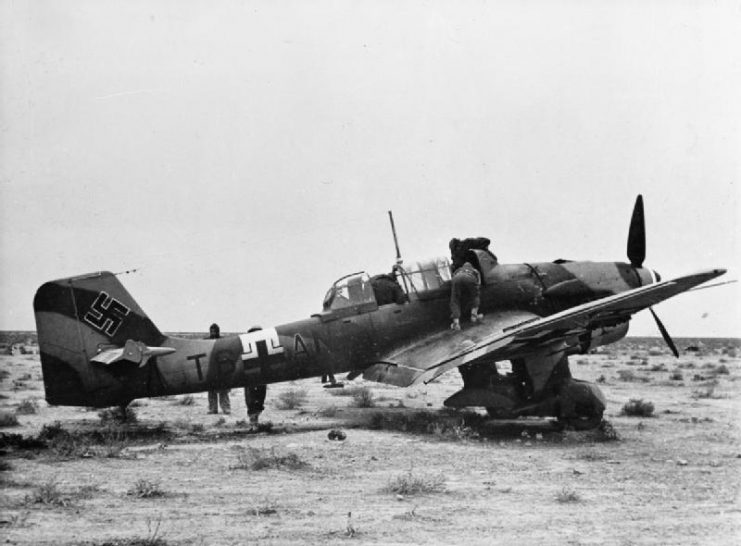 A Ju 87 B of 5/StG 2 is examined by British troops after making an emergency landing in the North African desert, December 1941.