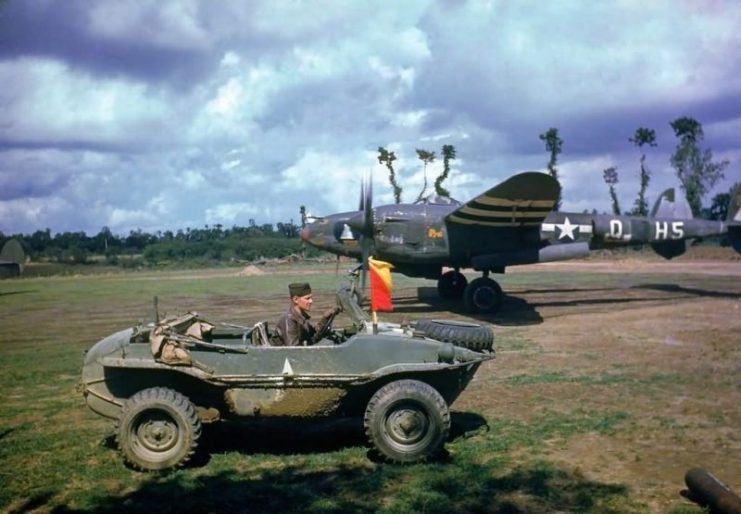 Colorized P-38 of the 392nd FS with a Schwimmagen in the foreground – 1944 France.