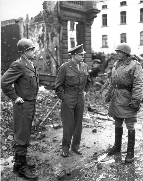 General Omar Bradley, General Dwight Eisenhower, and General George Patton, all graduates of West Point, survey war damage in Bastogne, Belgium