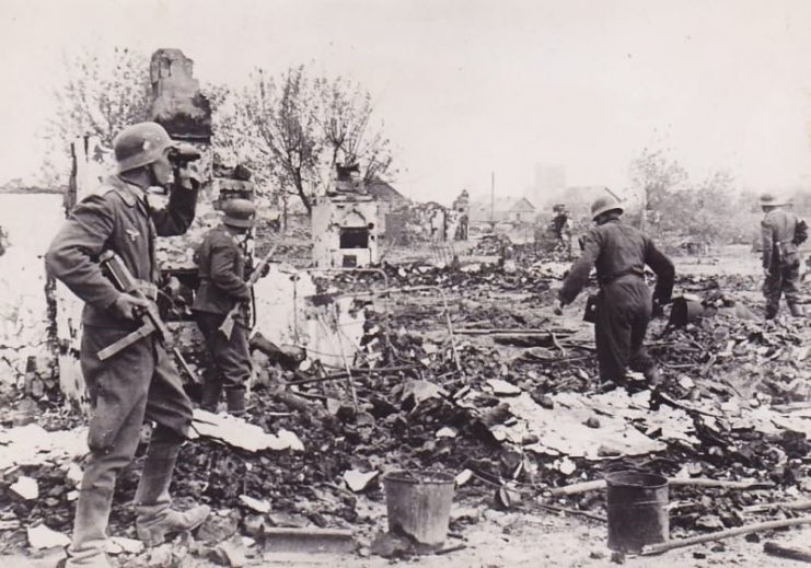 German Troops Advancing Through Housing Ruins.