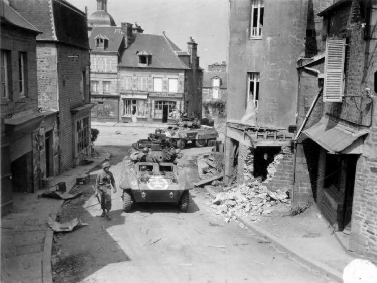 Greyhounds of Company C 82nd Recon Battalion, 2nd Armored Division pass through the road junction at St. Sever Calvados on 3 August 1944. Operation Cobra.